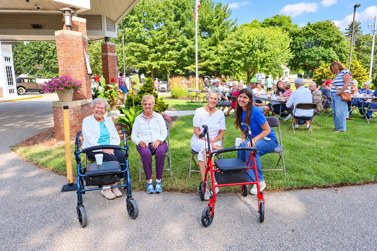 Photo of three residents and one staff member - all female - enjoying time outside on chairs.